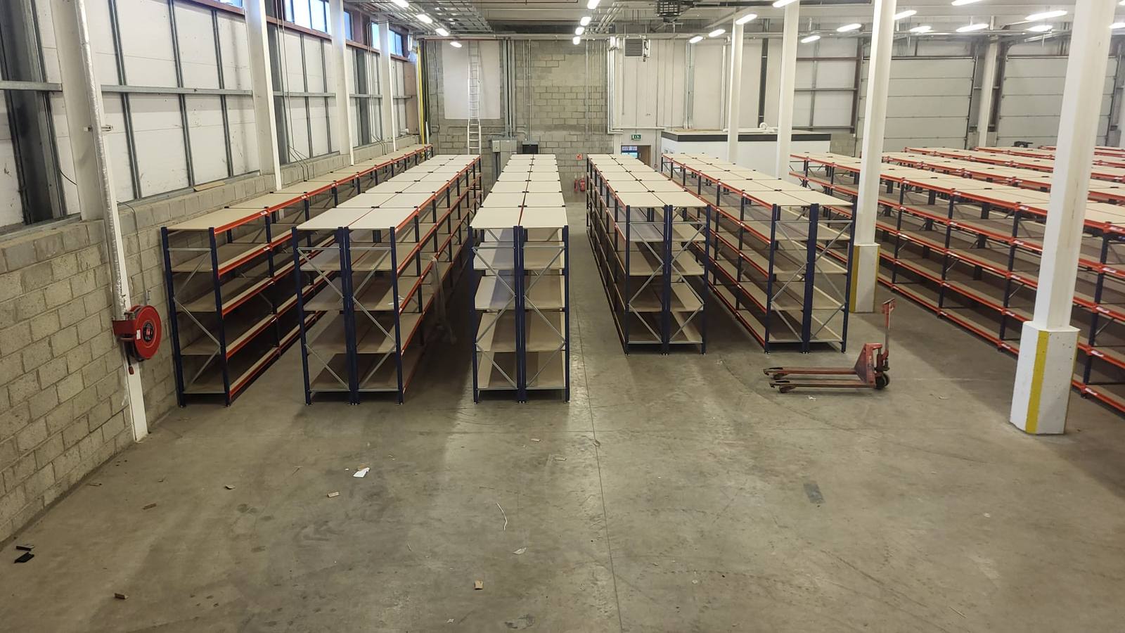 Long span bays staged across a warehouse floor before installation