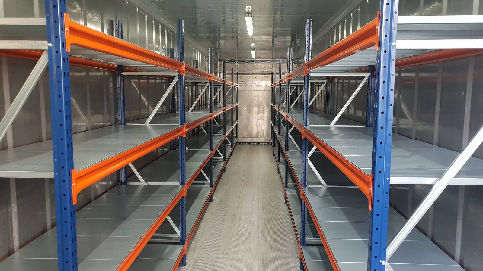 Shelving fitted along both walls inside a container
