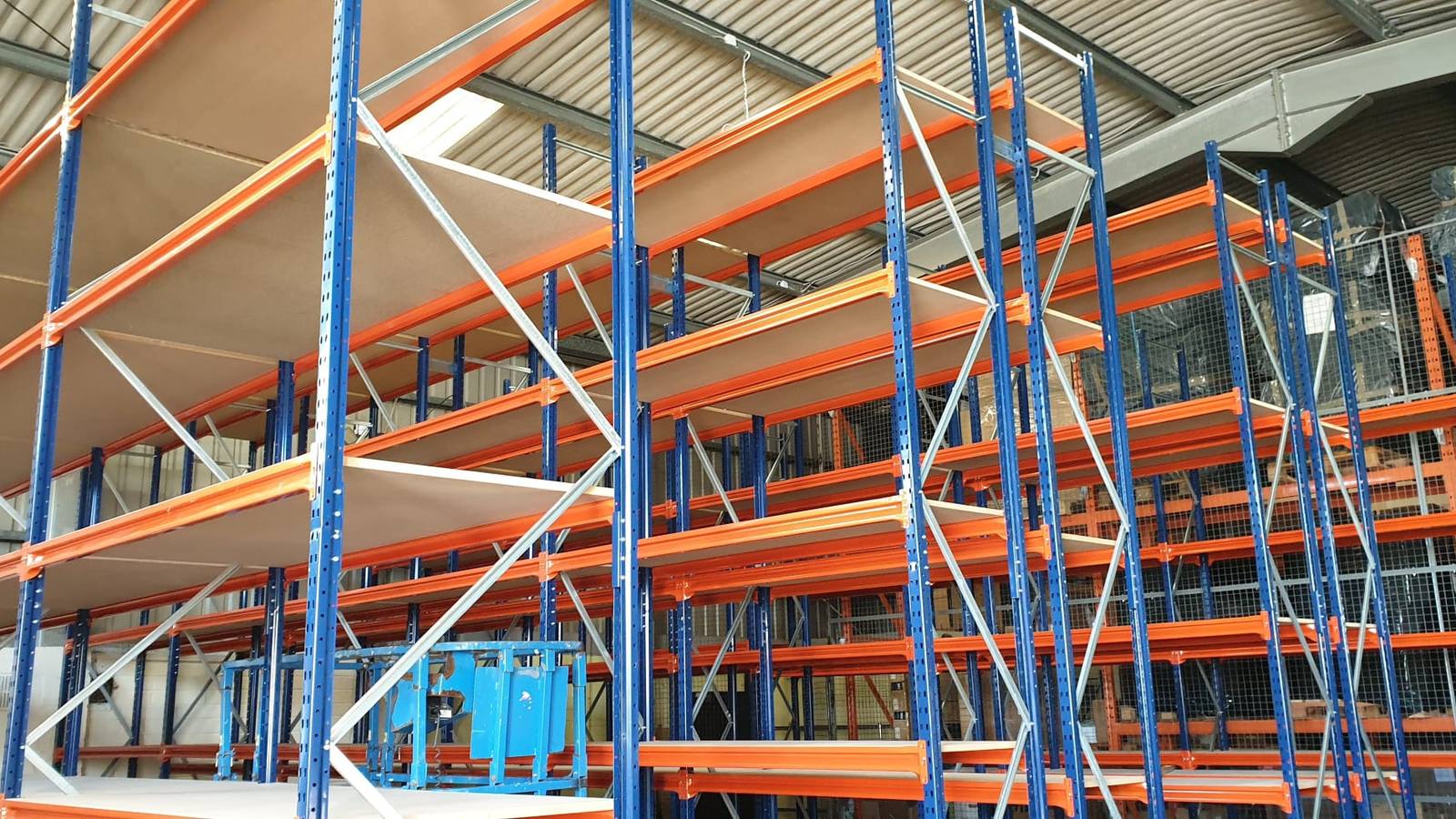 High-bay long span shelving run seen from the end of the aisle